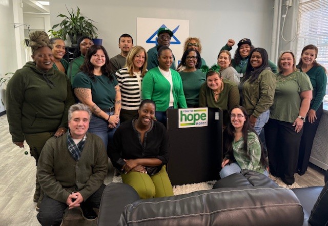 Group of people smiling while posing for a picture